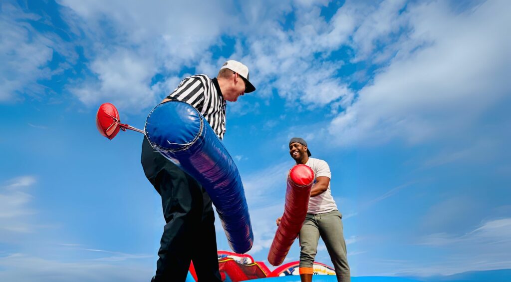 Employees jousting at field day